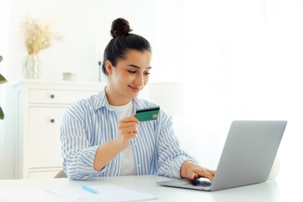 Transferring money, e-banking, online shopping. Beautiful happy indian or arabian young woman