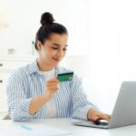 Transferring money, e-banking, online shopping. Beautiful happy indian or arabian young woman